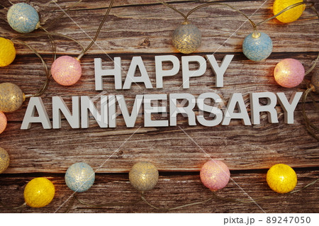 Happy Anniversary text with LED cotton balls decoration on wooden background Happy Anniversary text with LED cotton balls decoration on wooden background 89247050