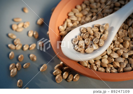 A bunch of cannabis seeds lie on a spoon and plate A bunch of cannabis seeds lie on a spoon and plate 89247109