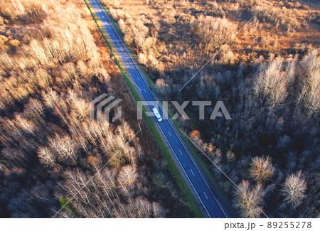 Highway in the forest with trees in the autumn season, top view. 89255278