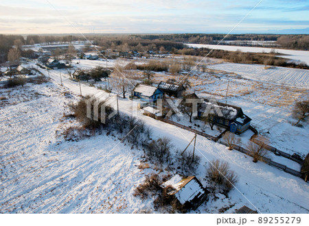 Wooden home in village in winter season. Country houses in countryside in snow. 89255279