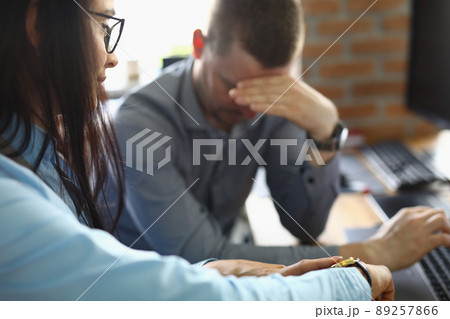 Businesswoman pointing at time to latecomer colleague Businesswoman pointing at time to latecomer colleague 89257866