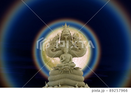 Moon corona light and Buddha protected by the hood of the mythical king naga on the night sky Moon corona light and Buddha protected by the hood of the mythical king naga on the night sky 89257966
