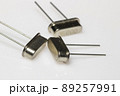Crystal resonator in metal body on white background. Electronic components. 89257991