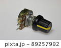 Potentiometer with knob on white background. Variable resistance. Electronic components. 89257992