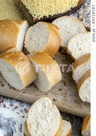 pieces of wheat baguette on a cutting board 89258587