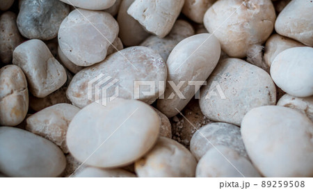 Close up natural white pebbles, texture of decorative stone gravel for background and design. Close up natural white pebbles, texture of decorative stone gravel for background and design. 89259508