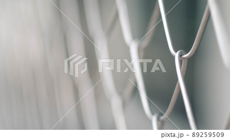 Close up Solid Metallic Wire Mesh Chain link Fence in Vintage Style Steel. Selective focus wire mesh fence 89259509