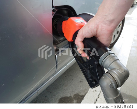 セルフガソリンスタンドで給油する手元のアップ 89259831