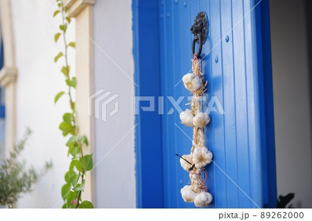 The door of a house in city of Polis in Cyprus is decorated with a bunch of garlic. 89262000