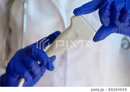Doctor prepares ultrasound machine for diagnosing patient Doctor prepares ultrasound machine for diagnosing patient 89264049