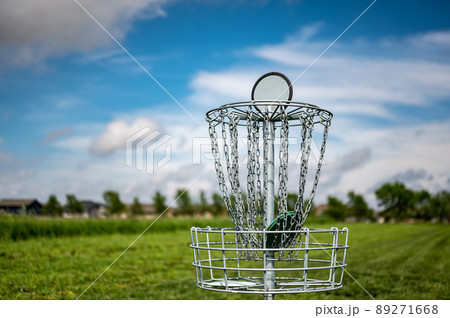 Side view with selective focus on the goal of a disc golf course Side view with selective focus on the goal of a disc golf course 89271668