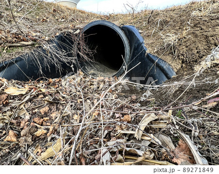 HDPE drainage culvert under a road entrance. Pipe is used to convey stormwater between ditches. 89271849