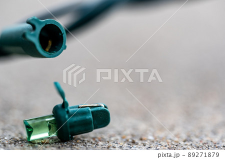 Focus on replacement bulb for a string of Christmas lights to repair a dud. Focus on replacement bulb for a string of Christmas lights to repair a dud. 89271879