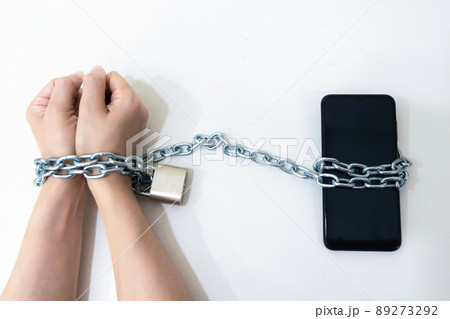 Mobile phone chained social media concept to the hands telephone 89273292