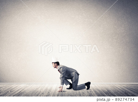King businessman in elegant suit running in empty room 89274734