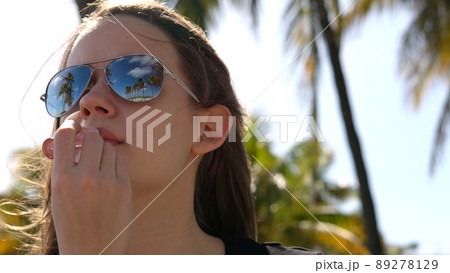 Young woman applies Lip gloss - close up shot Young woman applies Lip gloss - close up shot 89278129