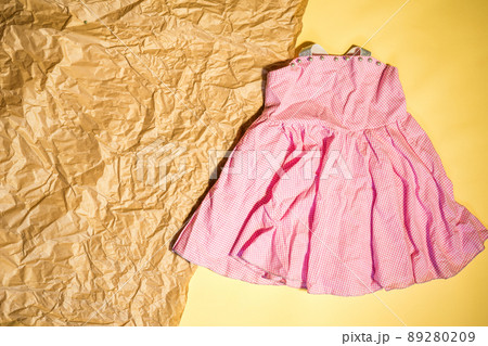 baby pink dress with space for text flat lay 89280209