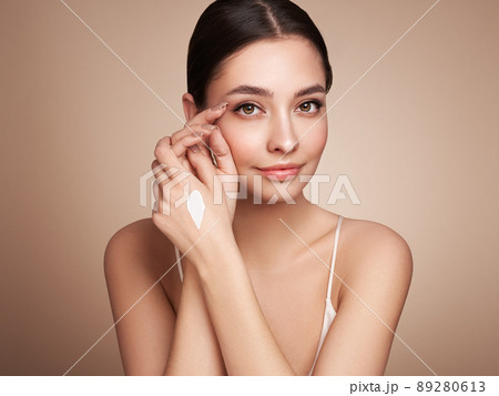 Beauty woman applying cream on her hands 89280613