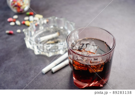 alcohol, pills and cigarette on table alcohol, pills and cigarette on table 89283138