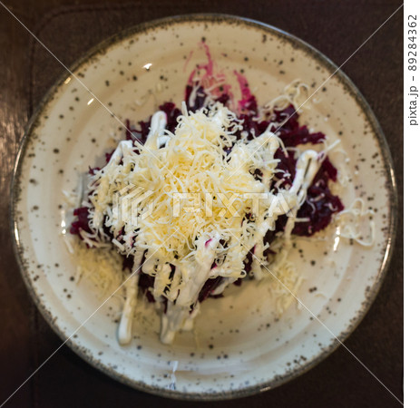mix of beets, cheese, mayonnaise on a plate in restaurant. top view mix of beets, cheese, mayonnaise on a plate in restaurant. top view 89284362