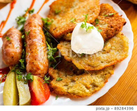 belarusian pancakes with sausages in a restaurant belarusian pancakes with sausages in a restaurant 89284396