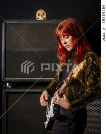 Young woman guitarist in a recording studio Young woman guitarist in a recording studio 89284564