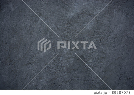 Gray dark concrete wall with bumps and scratches. 89287073
