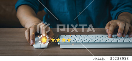 Close up man using mount computer for rating feedback from customer service with annual survey with five gold star icon. Business annual satisfaction survey concept. User reviews and feedback online. 89288958