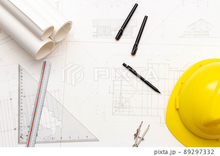 Mockup of architectural concept, Drawing tools and engineer drawing on blueprint with safety helmet Mockup of architectural concept, Drawing tools and engineer drawing on blueprint with safety helmet 89297332