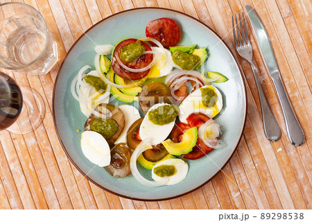 Caprese salad with avocado served on plate 89298538