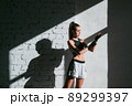 Close up of one young woman wrapping hands with black boxing wraps in gym practice boxing indoor working out fitness female lifestyle 89299397