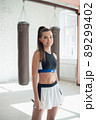 Cute young girl jumping rope in gym, warm up before training 89299402