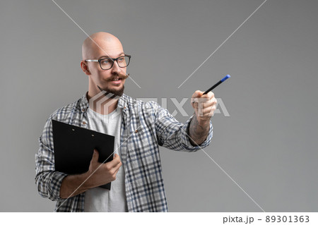 man caucasian teacher professor lecturing while pointing on space isolated on gray background man caucasian teacher professor lecturing while pointing on space isolated on gray background 89301363