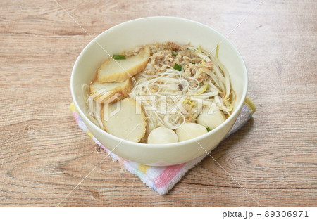 vermicelli rice noodles topping chop boiled pork and fish ball in soup on bowl 89306971