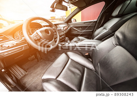 Car inside. Interior of prestige modern car. Comfortable leather seats. Black cockpit with on isolated white background. Car inside. Interior of prestige modern car. Comfortable leather seats. Black cockpit with on isolated white background. 89308243