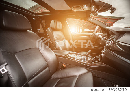 Car inside. Interior of prestige modern car. Comfortable leather seats. Black cockpit with on isolated white background. 89308250
