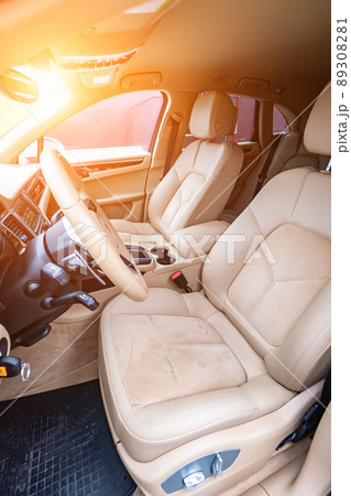 Car interior luxury. Beige comfortable seats, steering wheel, dashboard, climate control, speedometer, display, wood decoration light 89308281