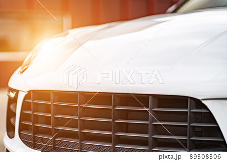 Compact white executive car, business car, large chrome grille. 89308306