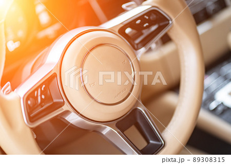multimedia control panel on the steering wheel of a modern car 89308315