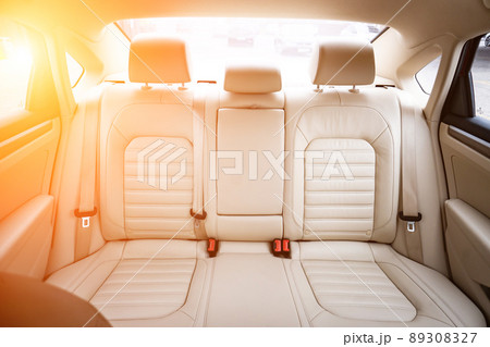 Car interior luxury. Beige comfortable seats, steering wheel, dashboard, climate control, speedometer, display, wood decoration light 89308327