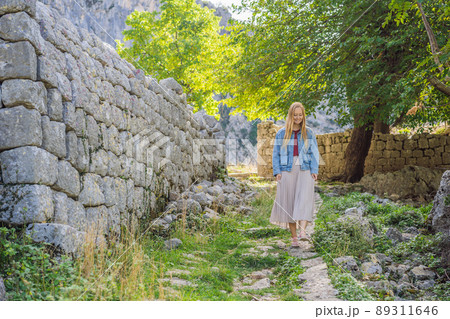 Woman tourist enjoys the view of Kotor. Montenegro. Bay of Kotor, Gulf of Kotor, Boka Kotorska and walled old city. Travel to Montenegro concept. Fortifications of Kotor is on UNESCO World Heritage Woman tourist enjoys the view of Kotor. Montenegro. Bay of Kotor, Gulf of Kotor, Boka Kotorska and walled old city. Travel to Montenegro concept. Fortifications of Kotor is on UNESCO World Heritage 89311646