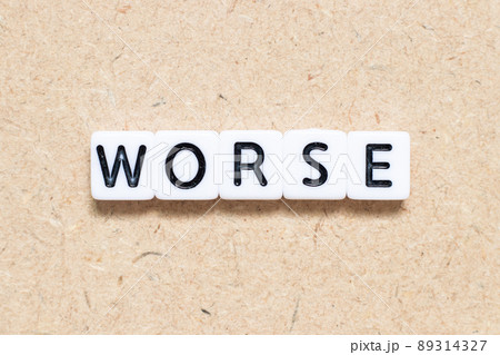 White tile alphabet letter with word worse on wood background White tile alphabet letter with word worse on wood background 89314327