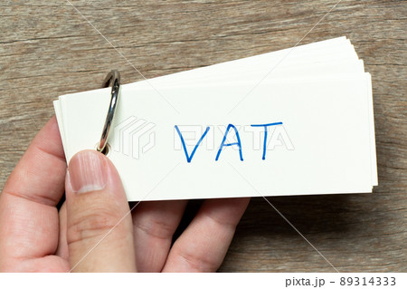 Man hold the flash card with handwriting word VAT (abbreviation of value added tax) on wood background Man hold the flash card with handwriting word VAT (abbreviation of value added tax) on wood background 89314333