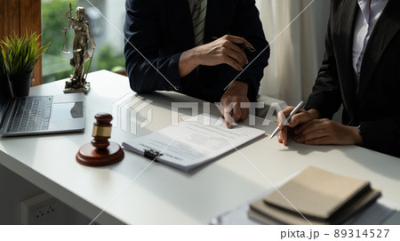client customer signing contract and discussing business with legal consultants, notary or justice lawyer with laptop computer and wooden judge gavel on desk in courtroom office, legal service concept client customer signing contract and discussing business with legal consultants, notary or justice lawyer with laptop computer and wooden judge gavel on desk in courtroom office, legal service concept 89314527