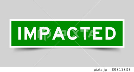 Sticker label with word impacted in green color on gray background Sticker label with word impacted in green color on gray background 89315333