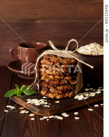 Homemade oatmeal cookies with banana, oats, nuts, eggs and flour free on brown dark wooden Homemade oatmeal cookies with banana, oats, nuts, eggs and flour free on brown dark wooden 89315648