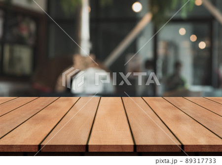 Empty wooden table top with lights bokeh on blur restaurant background. Empty wooden table top with lights bokeh on blur restaurant background. 89317733