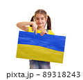 Girl holding Ukrainian blue and yellow flag 89318243