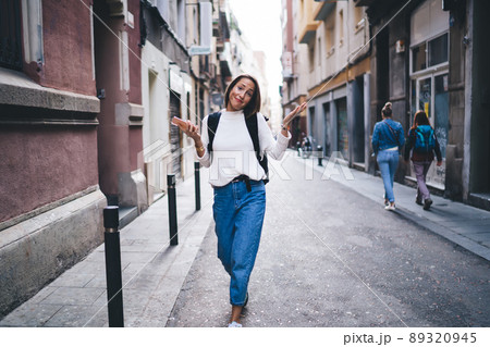 Caucasian female tourist with smartphone gadget searching location of quarter in town 89320945