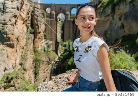 Tourist girl on the background of the famous bridge in Ronda, Spain 89321469